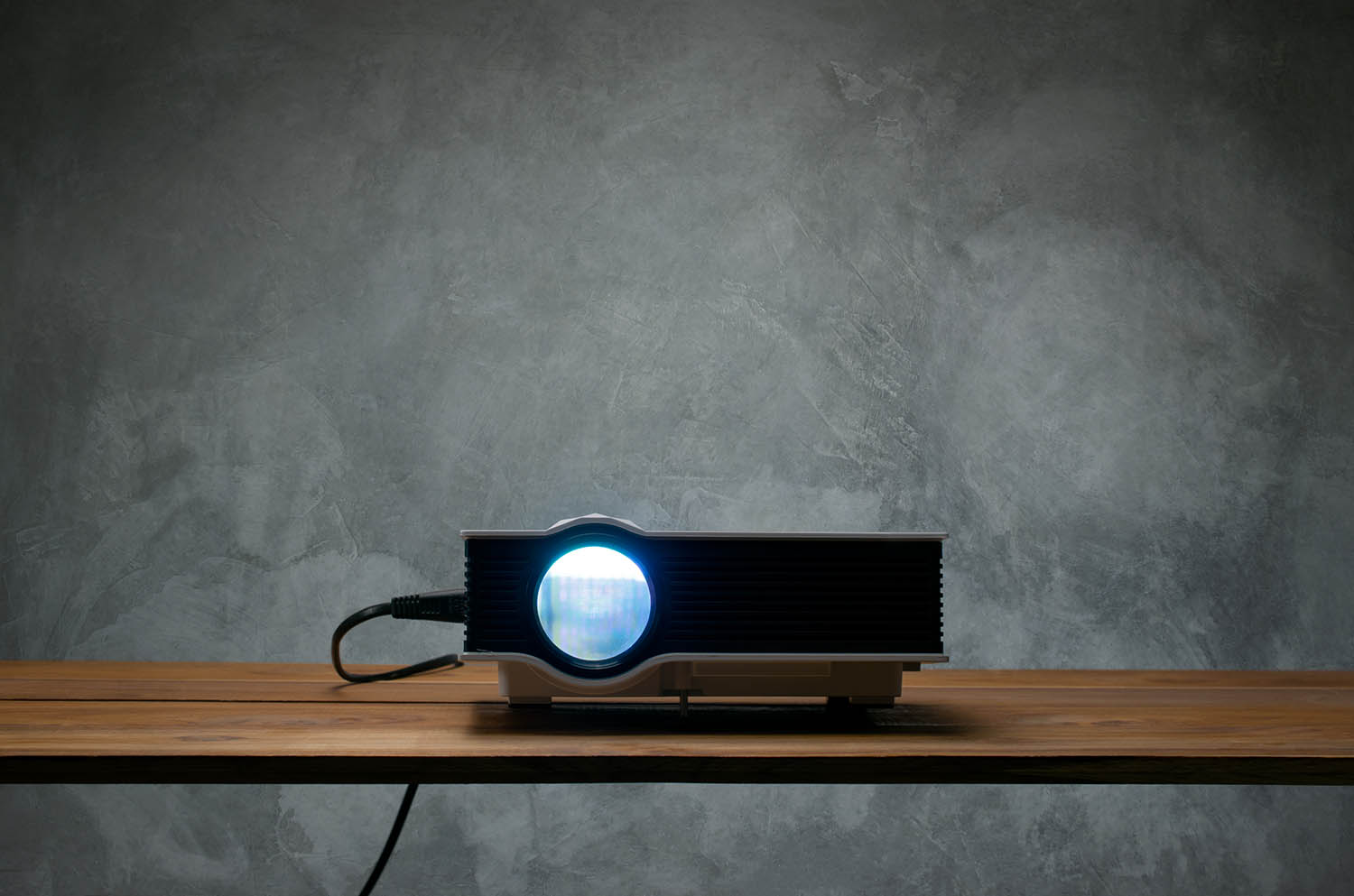 mini-led-projector-on-wood-table