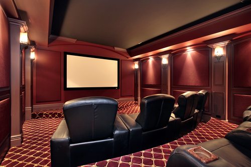 Theater in luxury home with large leather chairs